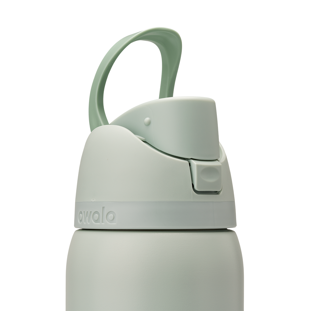 Owala FreeSip 32oz in Summer Paradise, lid detail showing closed flip cap with mint green carry loop arched over the top, sage body with embossed Owala logo and accent band at lid base
